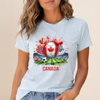 Soccer stadium, Canadian flag, and ball graphic on light blue t-shirt.