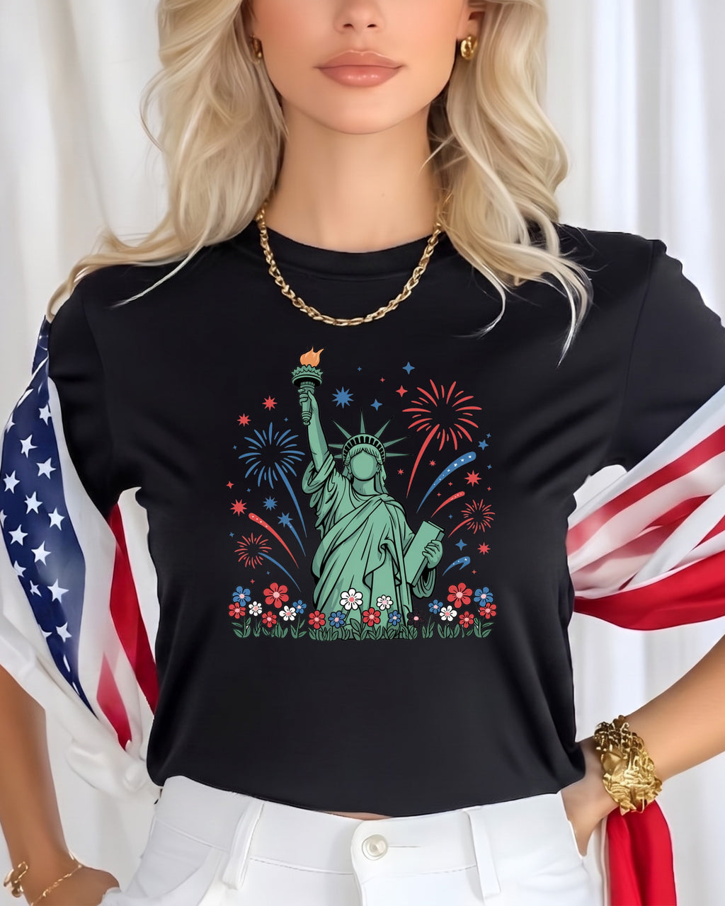 Black t-shirt with Statue of Liberty, fireworks, and flowers graphic.