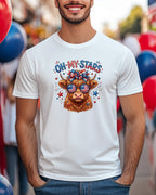 White t-shirt with "Oh My Stars" text and patriotic Highland cow graphic.