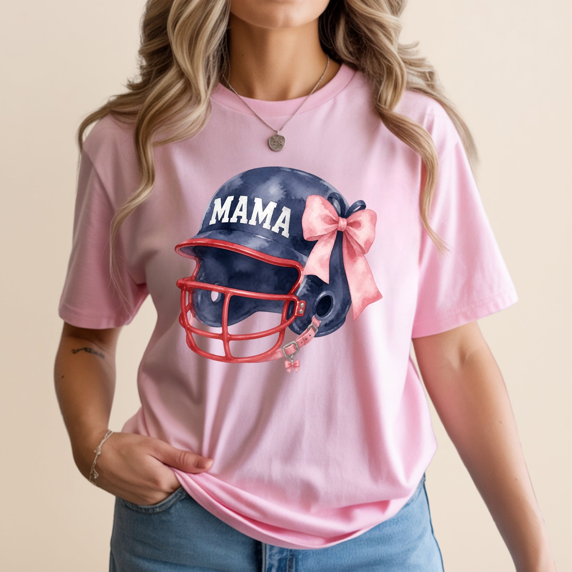 Pink t-shirt with a navy blue football helmet and pink bow graphic.