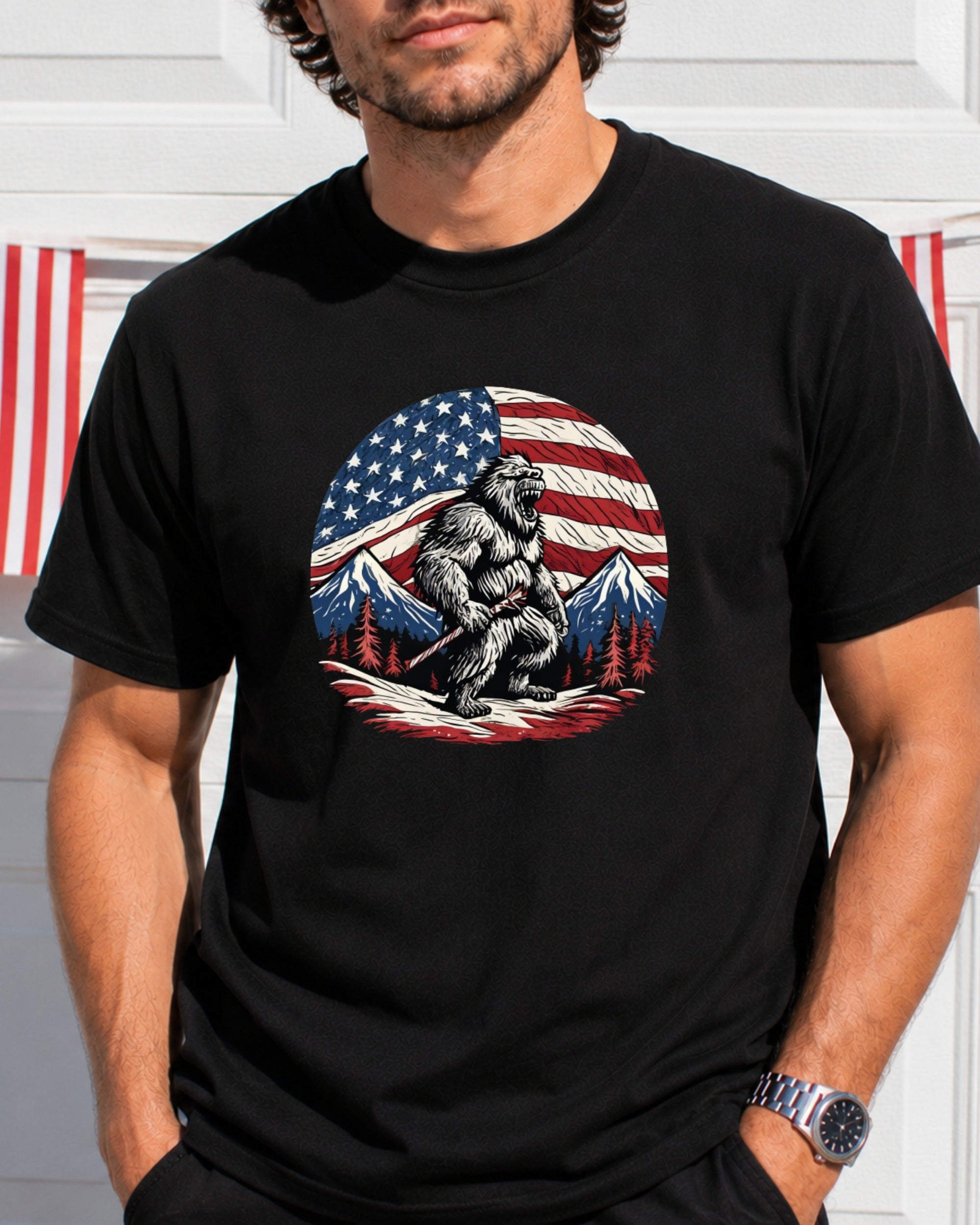Bigfoot in front of American flag and mountains, wearing a t-shirt.