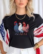 Three roosters with American flag patterns on a black t-shirt.