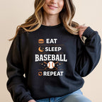 Black sweatshirt with "EAT SLEEP BASEBALL REPEAT" text and baseball icons.
