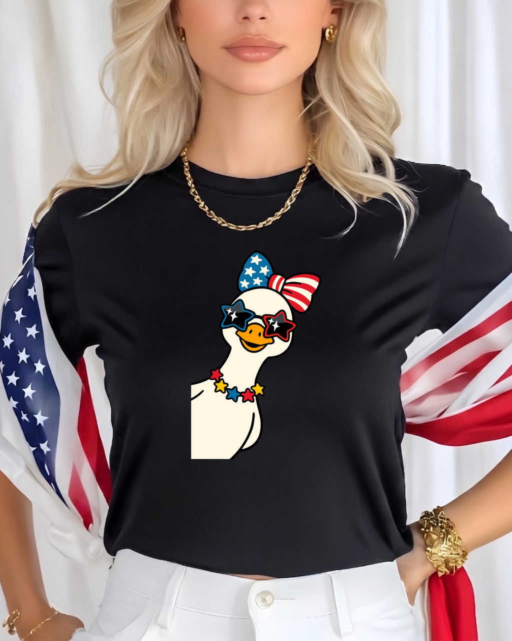 Goose wearing sunglasses, bow, and necklace against a black t-shirt with American flag accents.