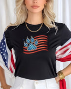 Black t-shirt with a patriotic paw print design and American flag stripes.