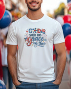 White t-shirt with "God Shed His Grace on Thee" in patriotic lettering.