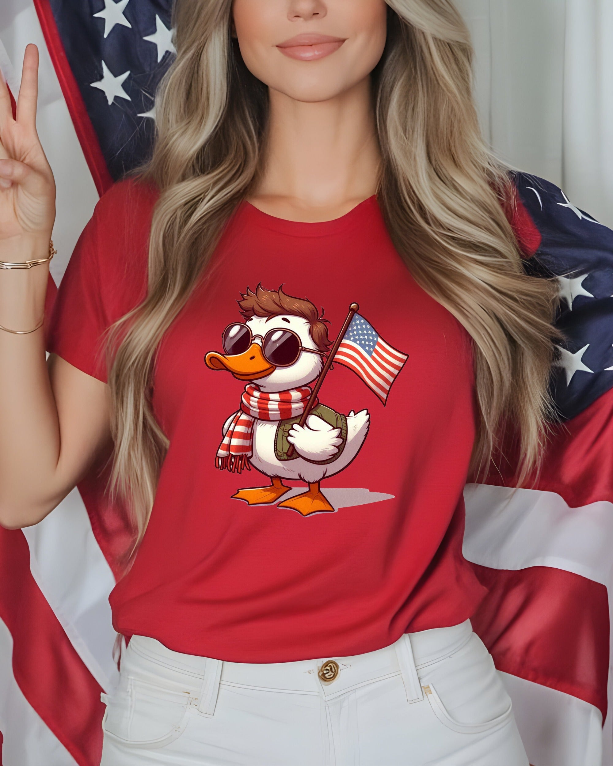 Duck in red shirt and sunglasses holding American flag.