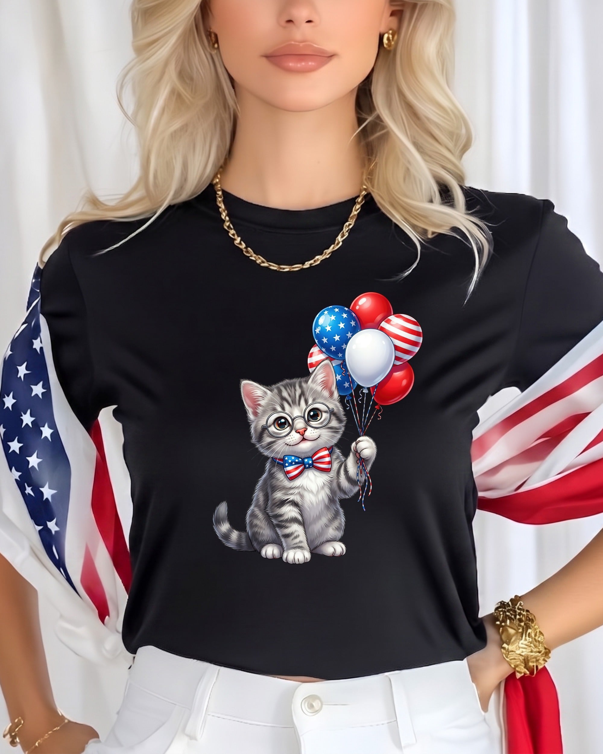 Cat wearing bow tie holding patriotic balloons, black t-shirt with US flag accents.