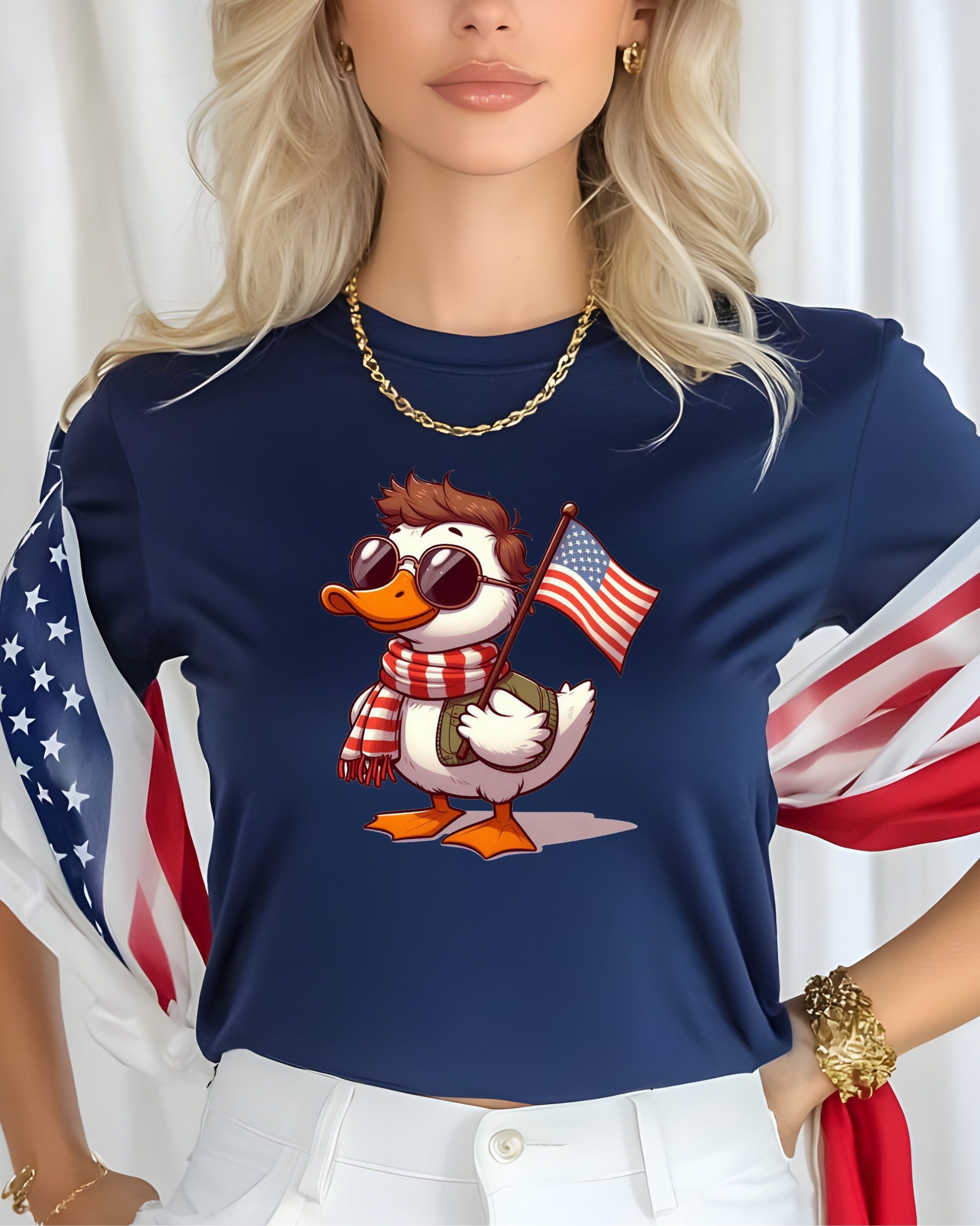 Cartoon duck wearing sunglasses and scarf holds American flag on navy t-shirt.