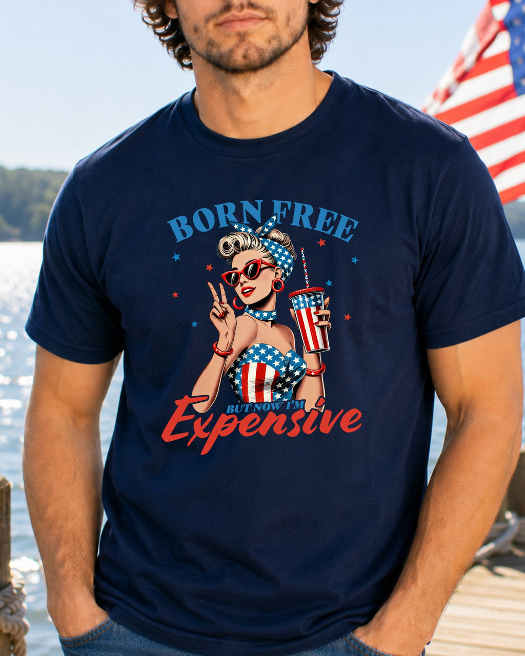 Man wearing a navy t-shirt with "Born Free But Now Expensive" graphic.