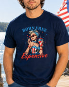 Man wearing a navy t-shirt with "Born Free But Now Expensive" graphic.