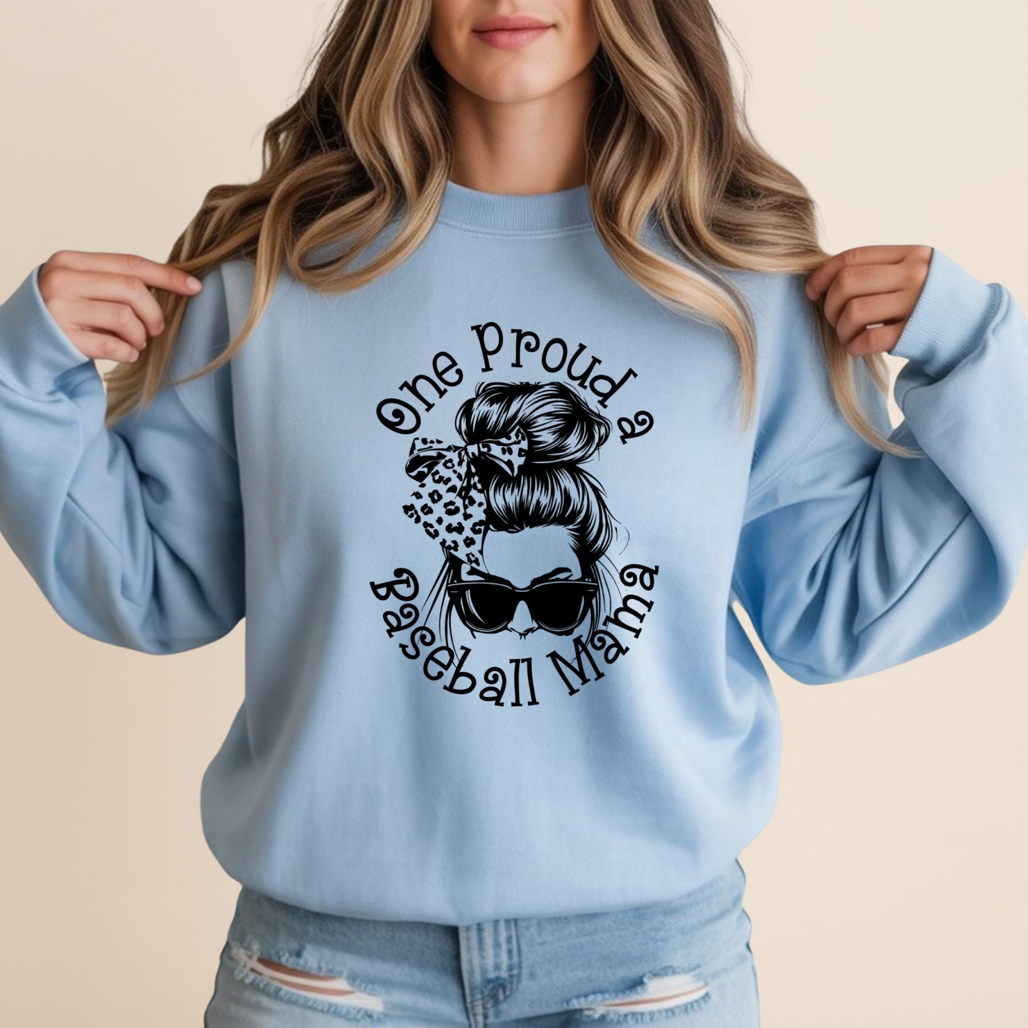 Light blue sweatshirt with "One proud baseball mama" and sunglasses graphic.