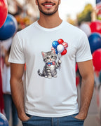 Gray kitten wearing a bow tie holding patriotic balloons.