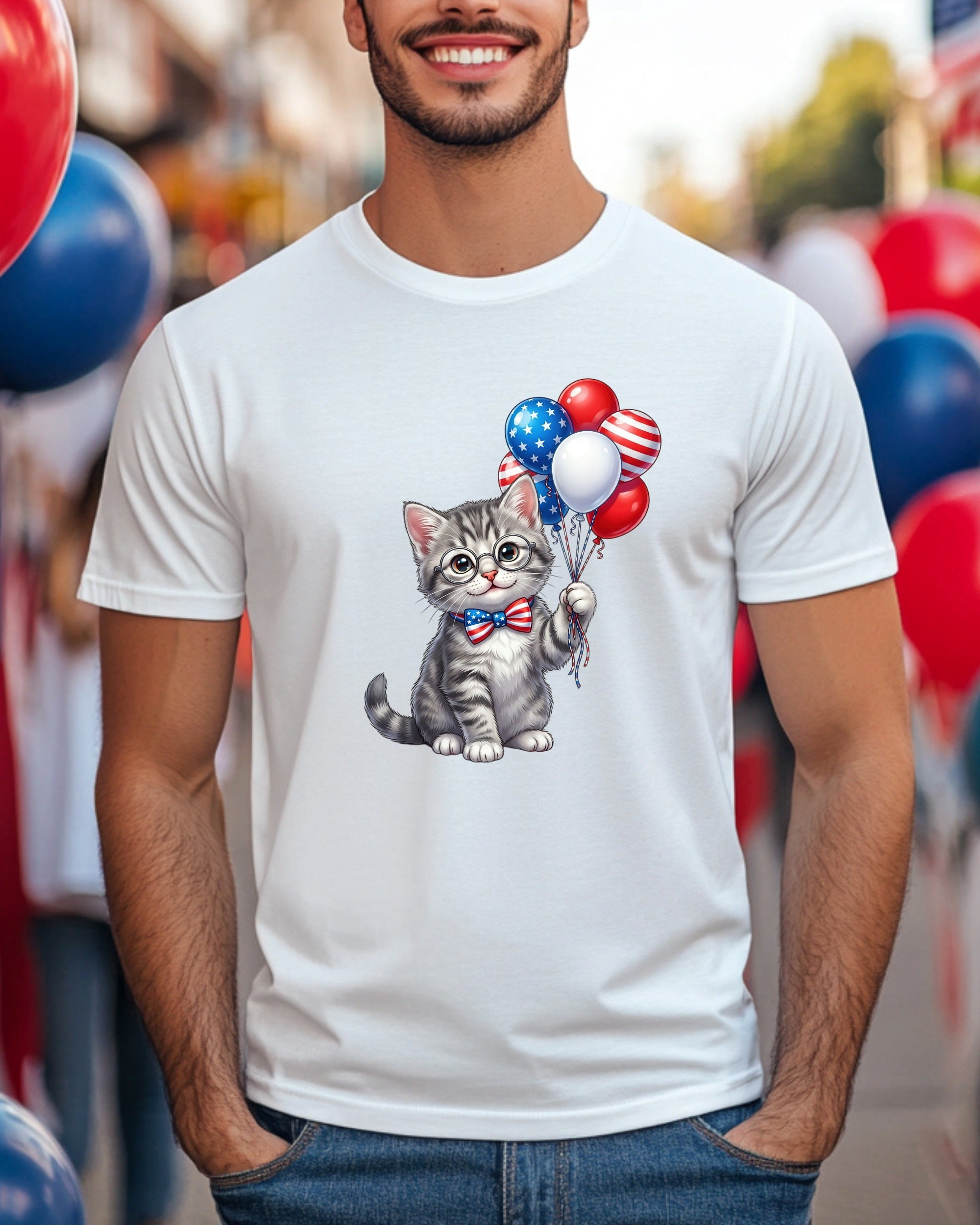 Gray kitten wearing a bow tie holding patriotic balloons.