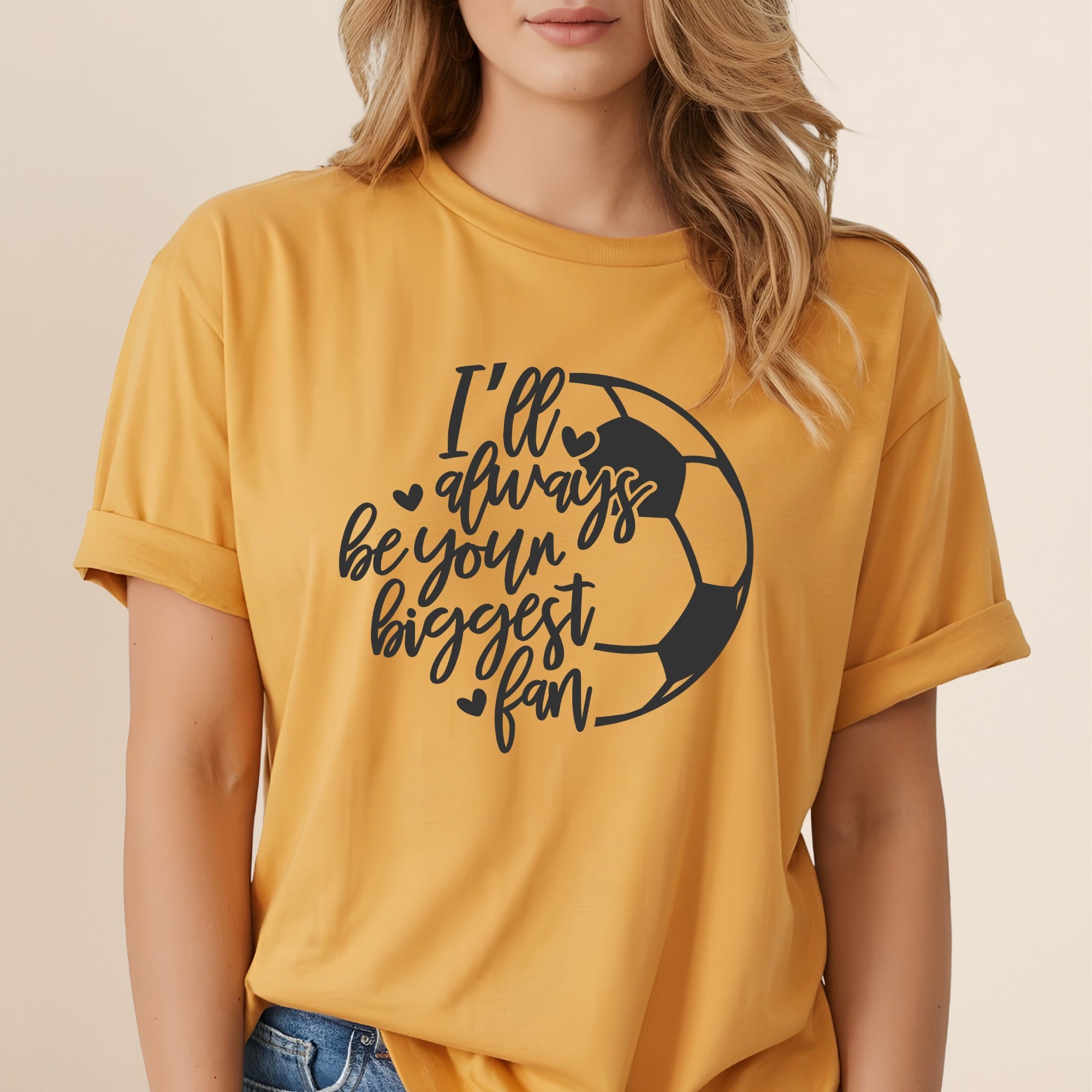 Yellow t-shirt with black graphic of a soccer ball and text "I'll always be your biggest fan".