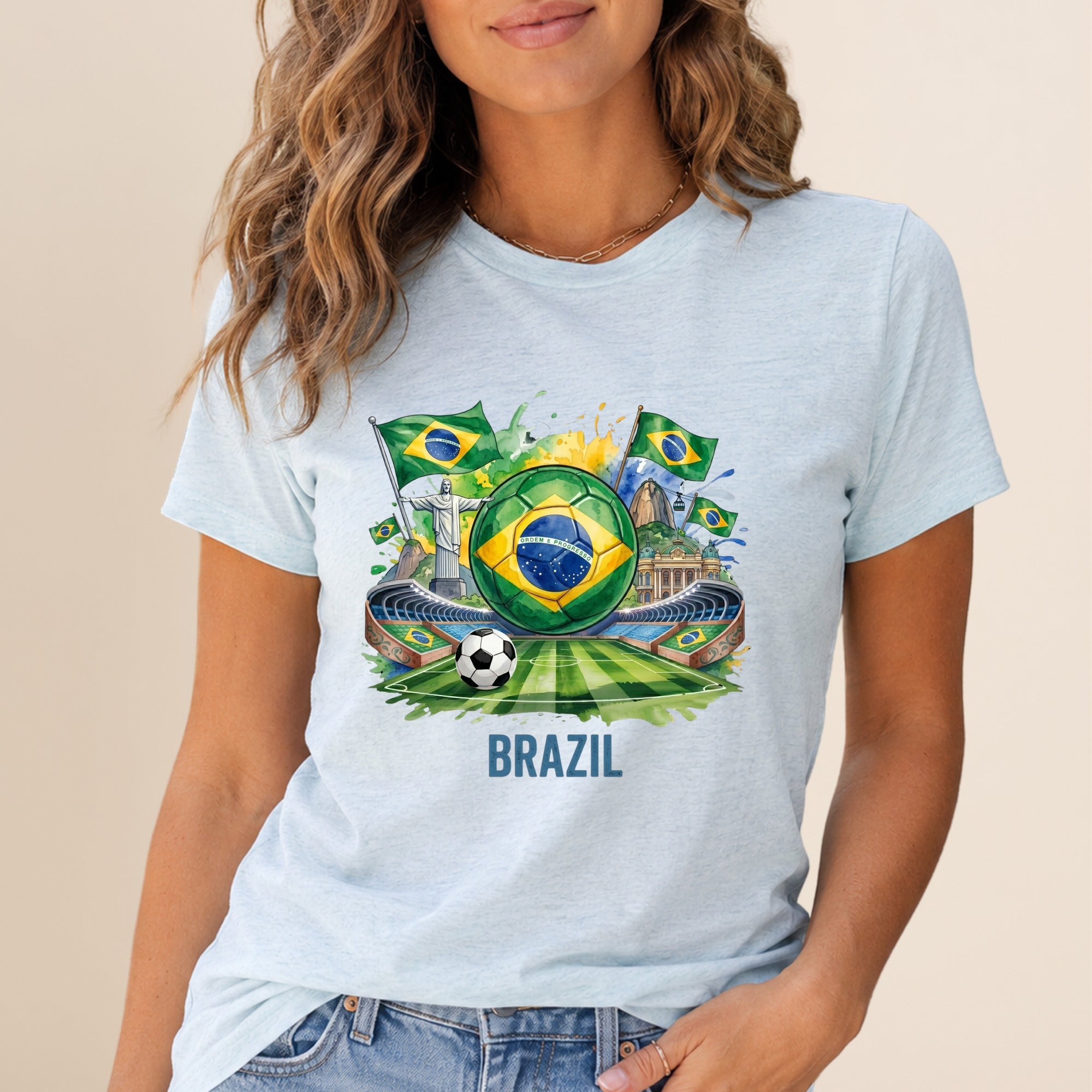 Soccer stadium with Brazil flags and soccer ball on a light blue t-shirt.
