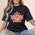 Black t-shirt featuring a maple leaf with Canada Soccer text and a golden soccer ball.