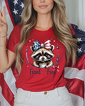 Red t-shirt with raccoon graphic and "Feral but free" text.
