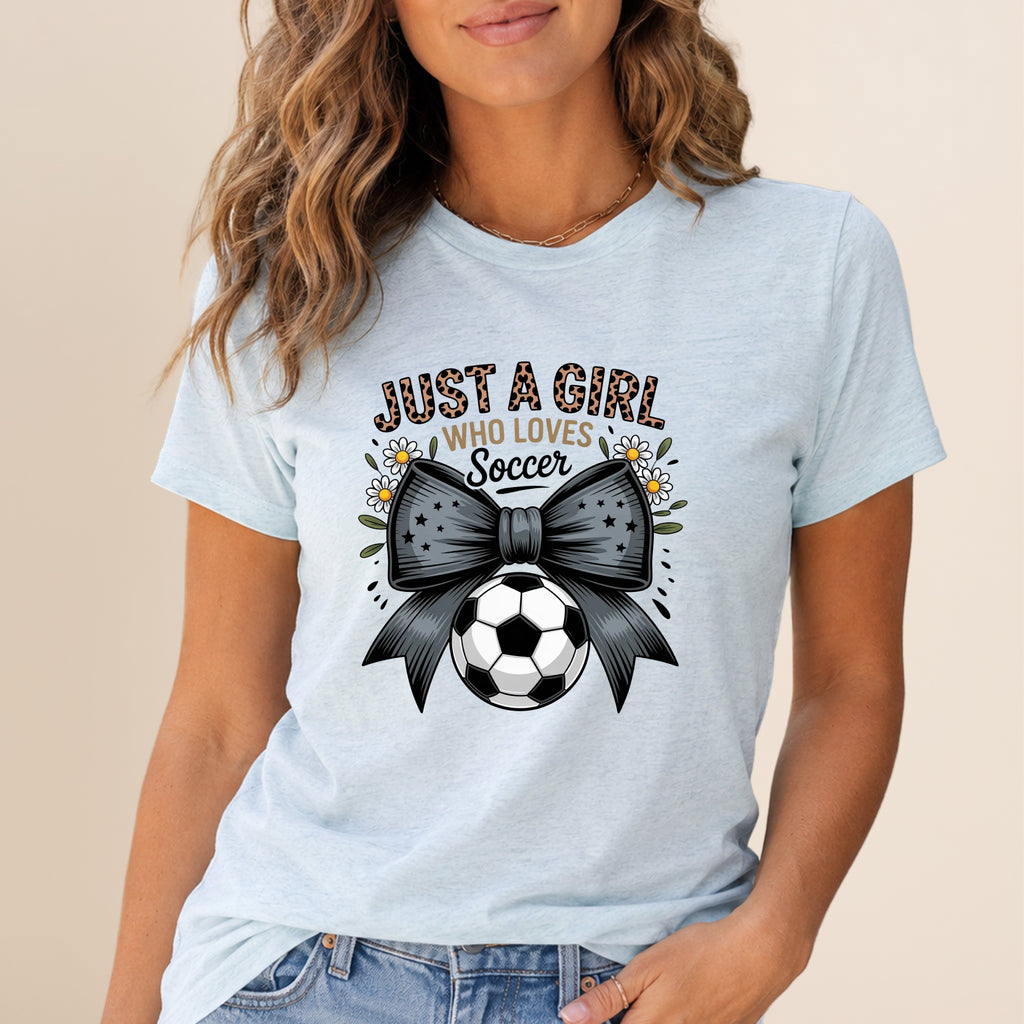 Light blue t-shirt with "Just a Girl Who Loves Soccer" text and a soccer ball bow.