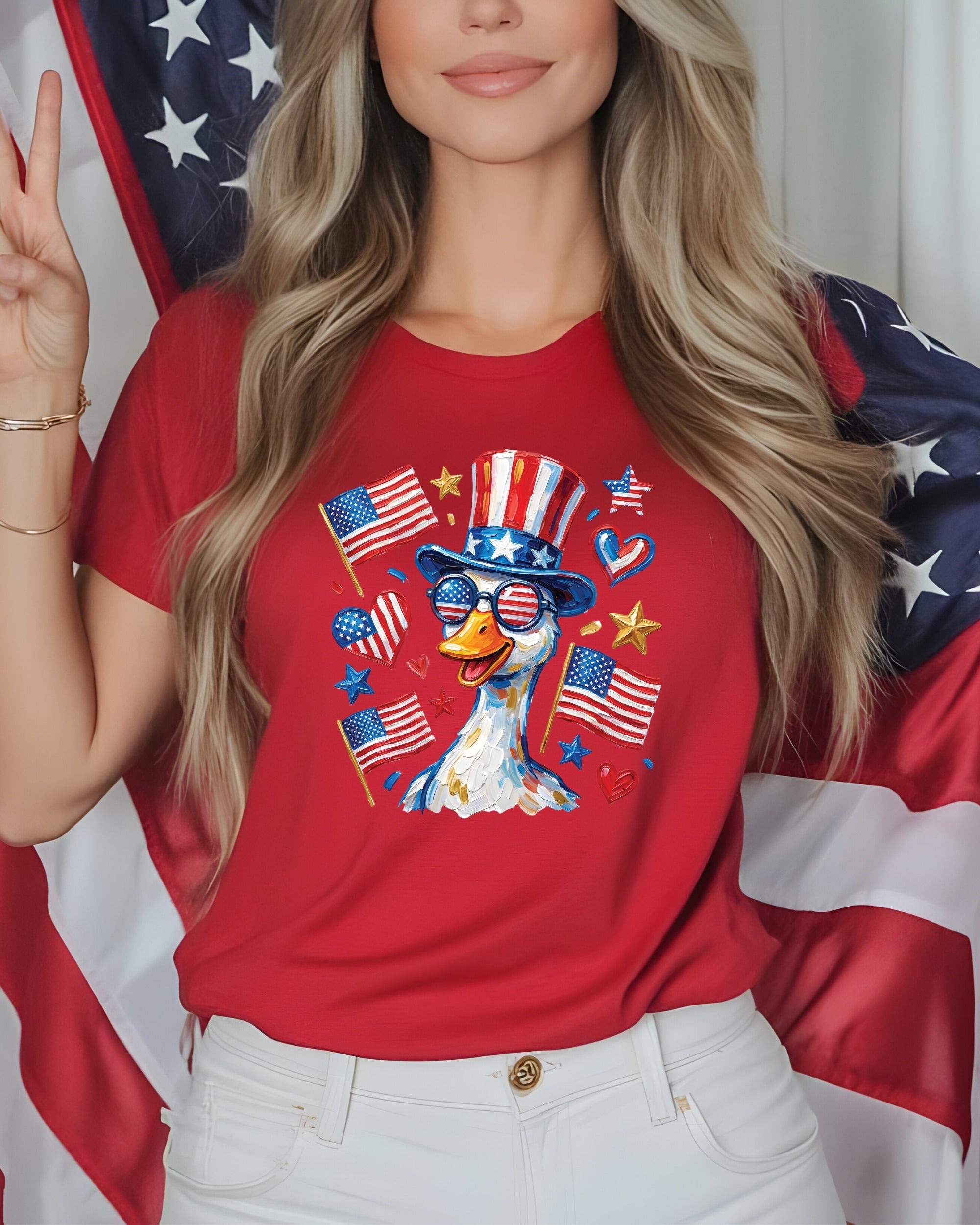 Red t-shirt with patriotic duck wearing sunglasses and hat, surrounded by American flags.