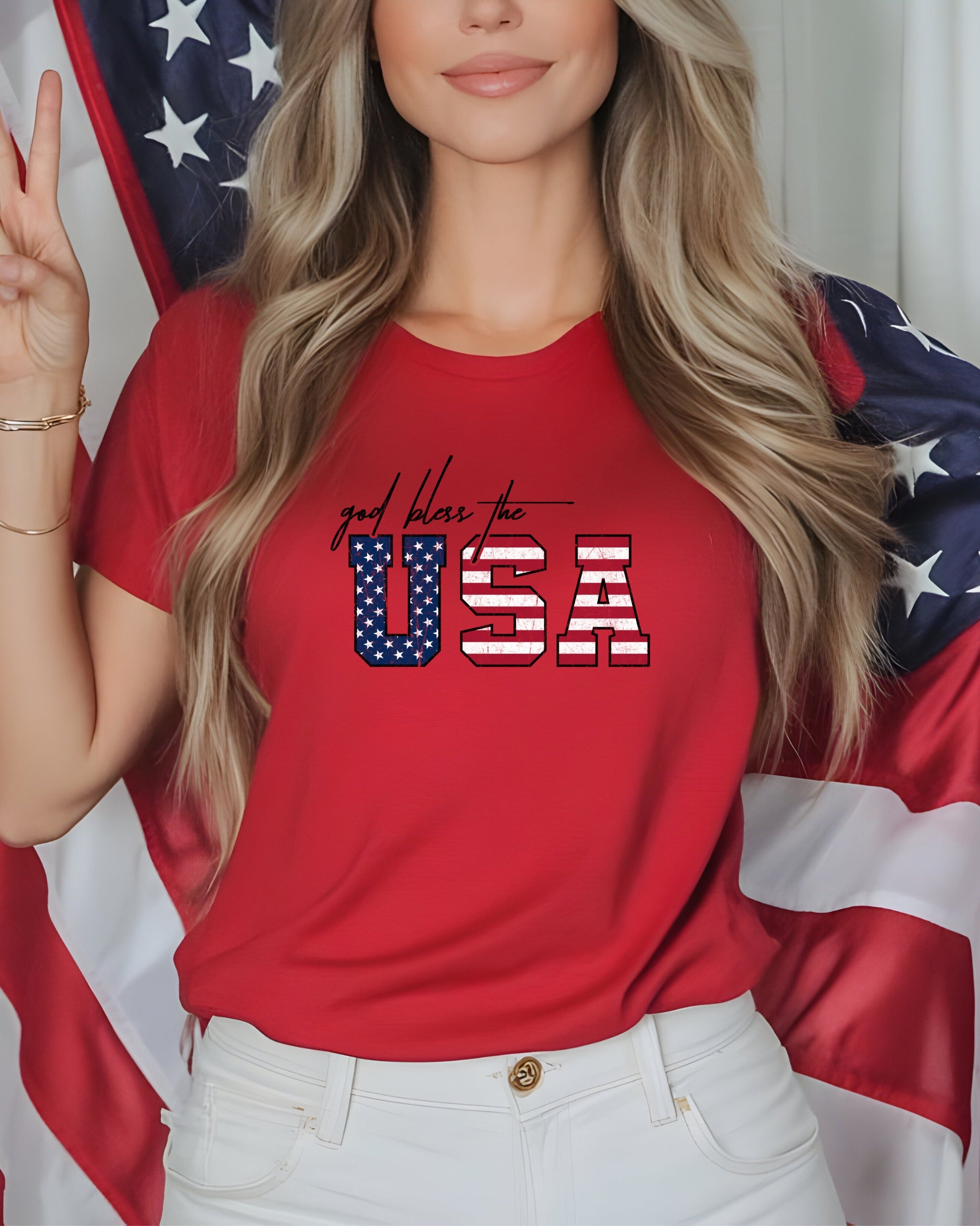 Woman in red "God Bless the USA" t-shirt holding American flag.