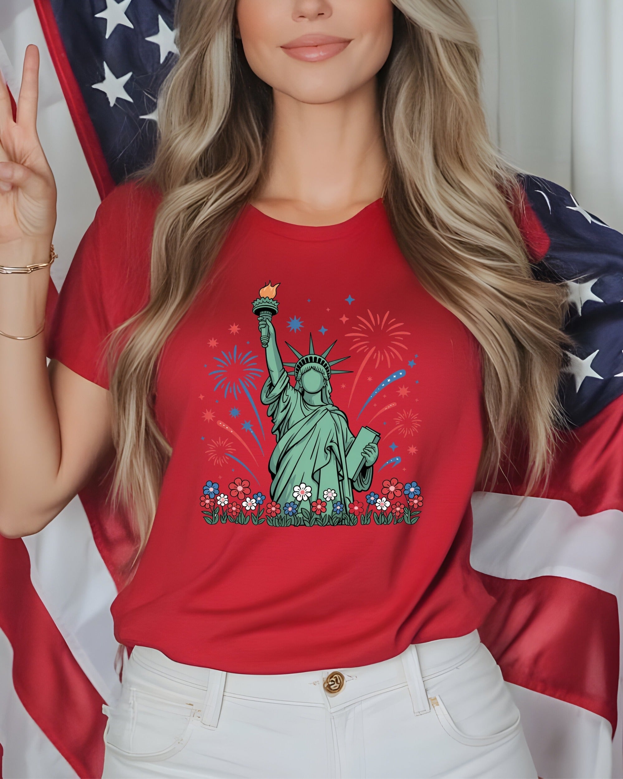 Red t-shirt with Statue of Liberty, fireworks, and flowers graphic.
