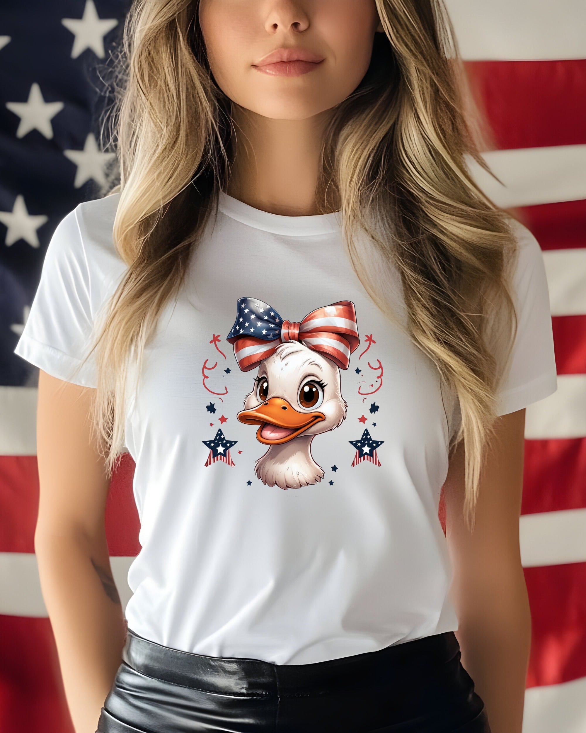 White t-shirt with a cartoon duck wearing a patriotic bow.