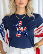 Dog-shaped balloon with American flag pattern on a navy blue t-shirt.