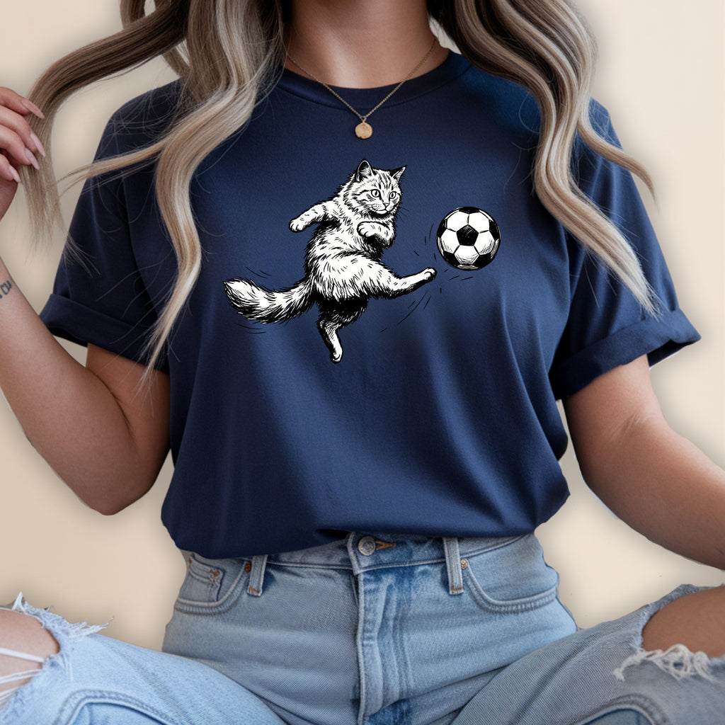 Cat kicking a soccer ball on a navy blue t-shirt.