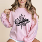 Pink sweatshirt with a black maple leaf design with "Canada" in the center.