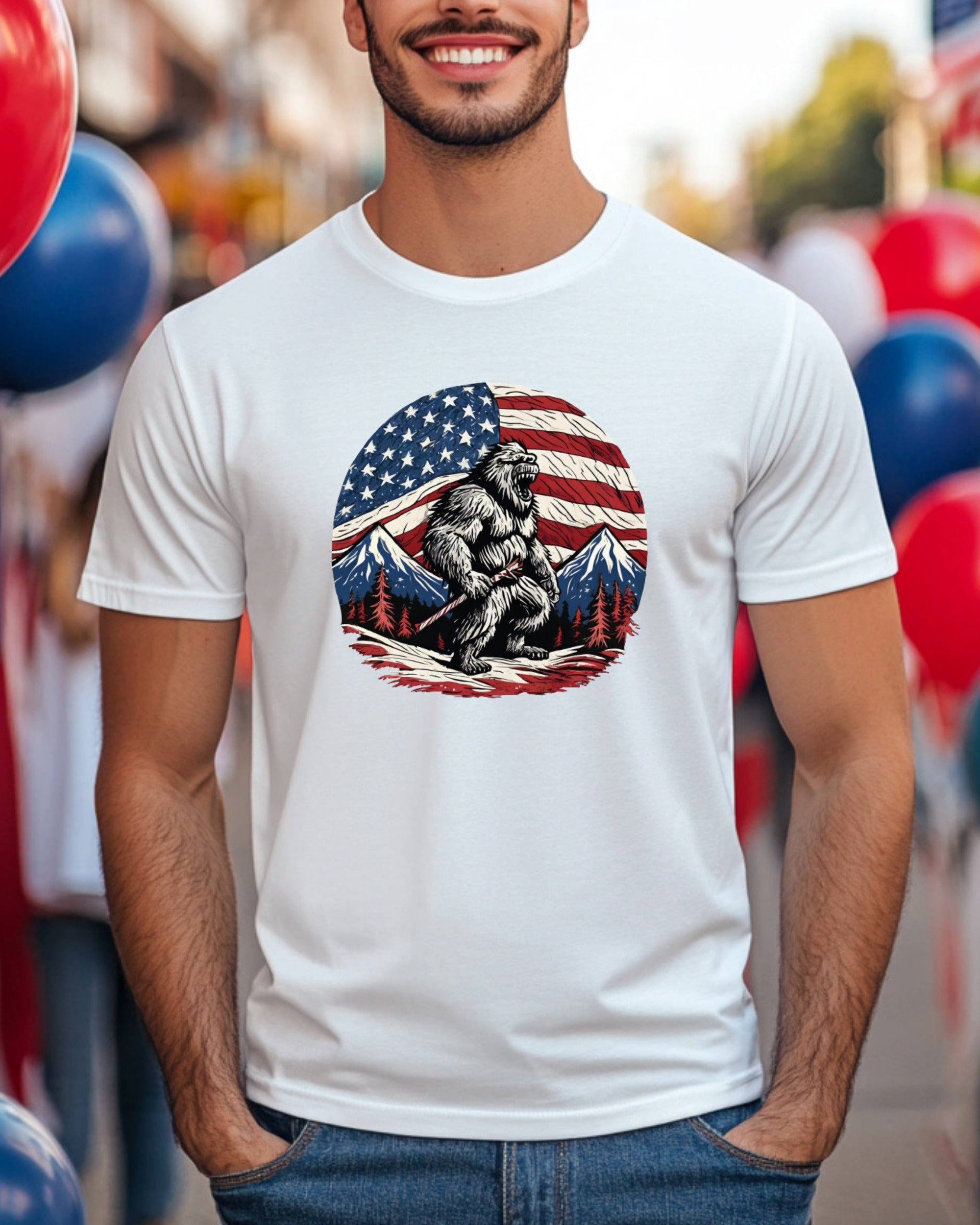 Bigfoot graphic with American flag and mountains on white t-shirt.