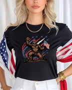 Bigfoot in patriotic attire holding US flag with fighter jets and fireworks.