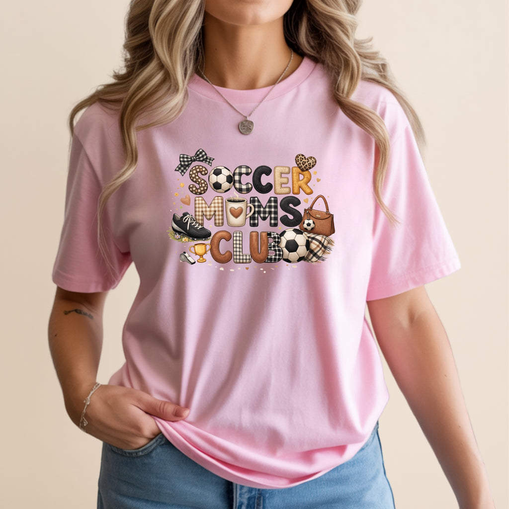 Pink t-shirt with "Soccer Moms Club" text and soccer-themed graphics.