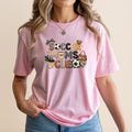 Pink t-shirt with "Soccer Moms Club" text and soccer-themed graphics.