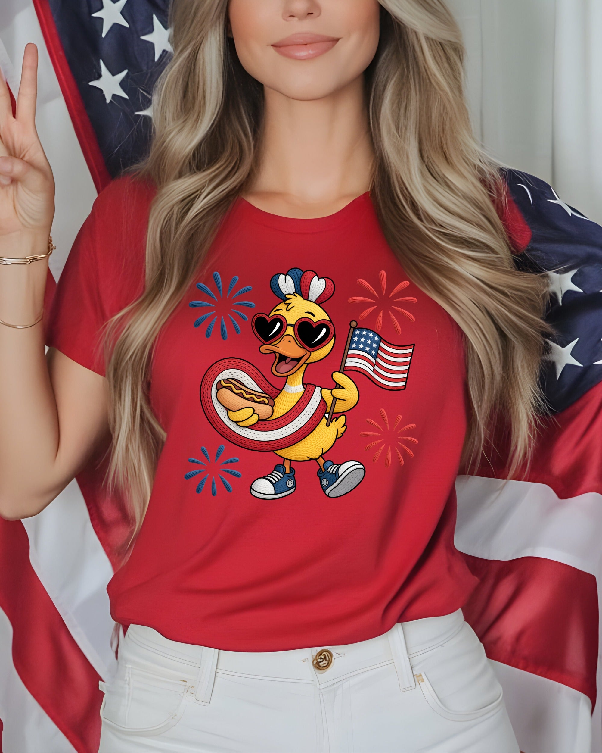 Duck wearing sunglasses and holding a hot dog, with American flag and fireworks.