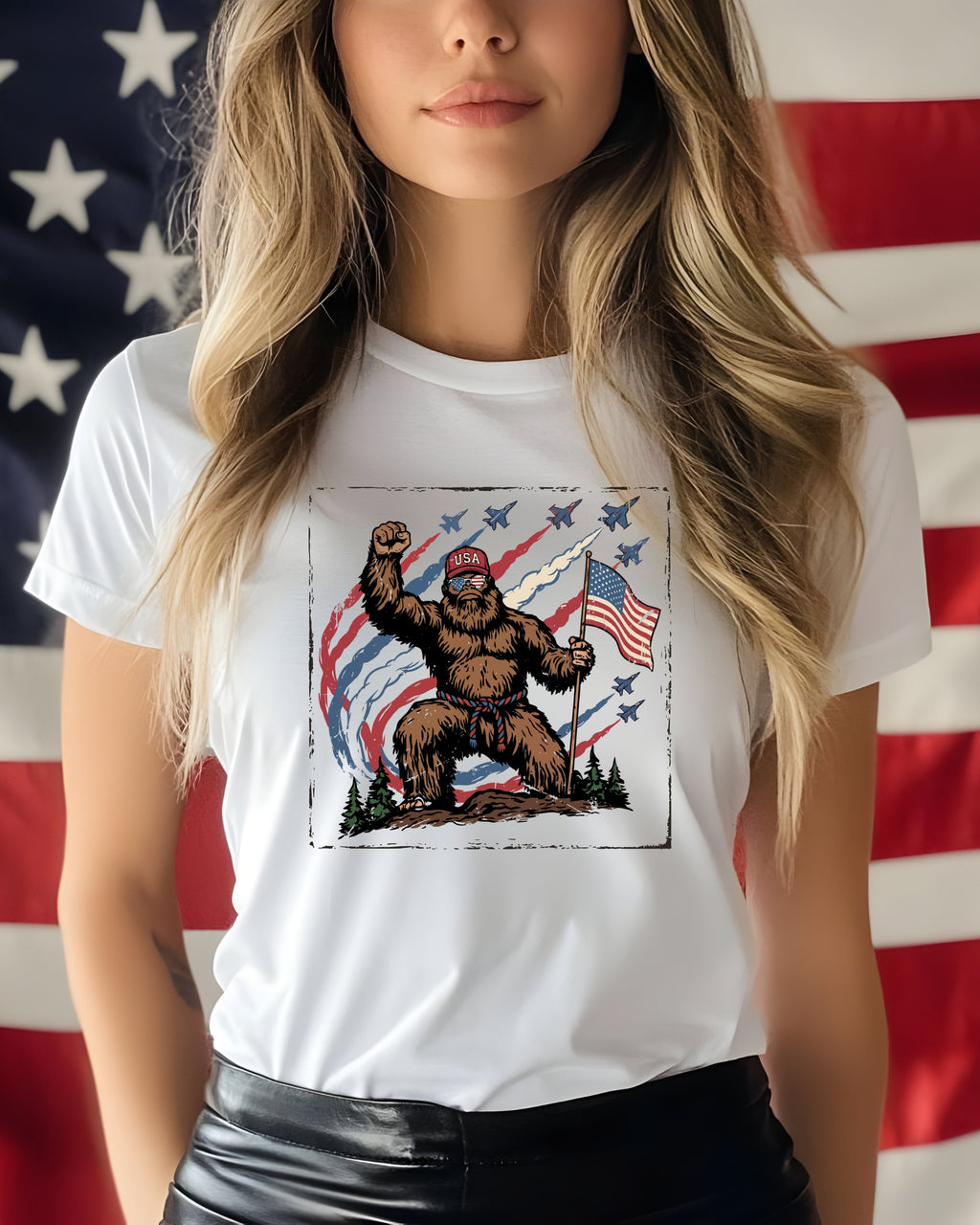 Bigfoot wearing a "USA" hat holds an American flag with jets flying overhead.