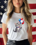 Cat wearing a bow tie holding patriotic balloons in front of a US flag.