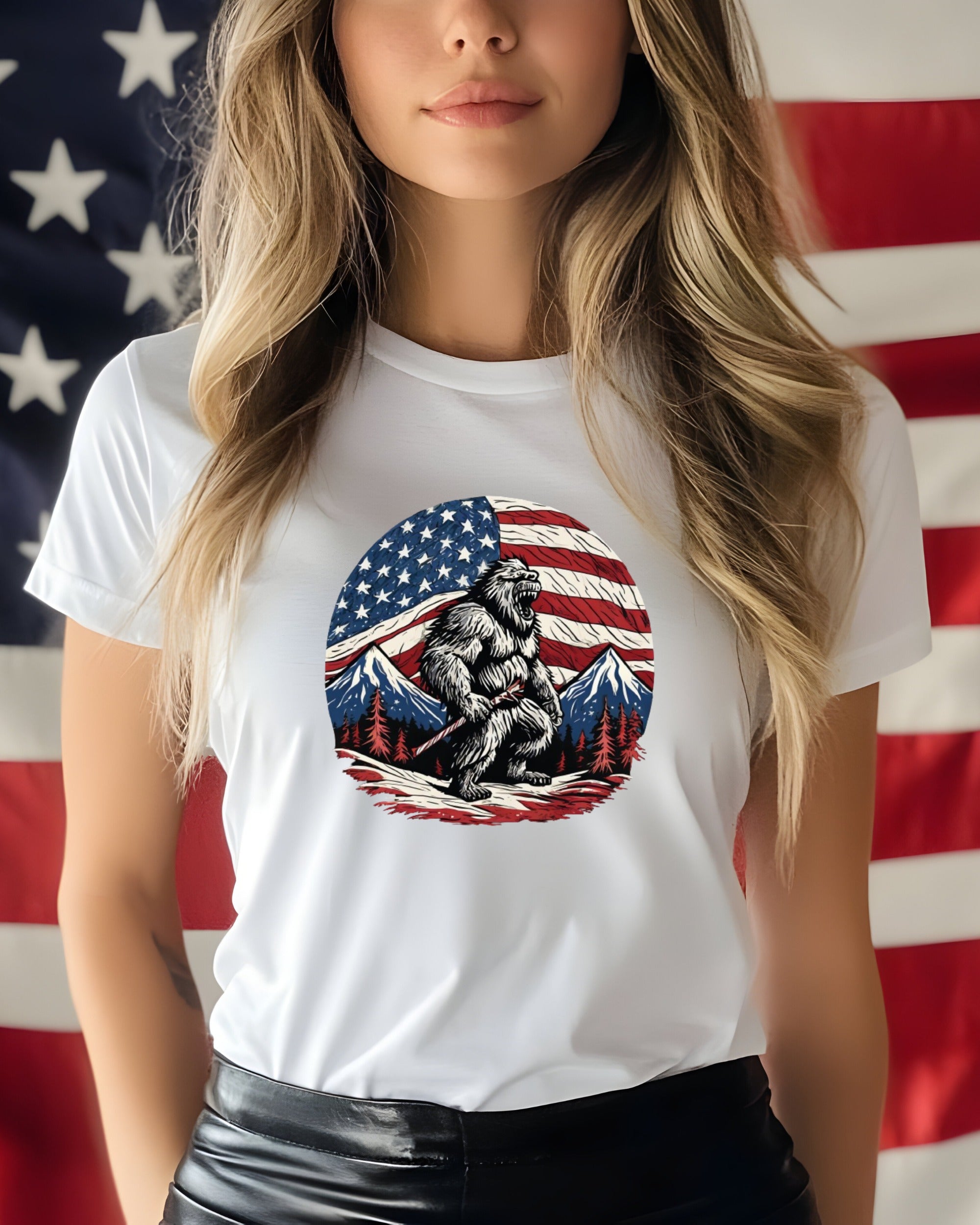 Bigfoot wearing a shirt printed with an American flag, mountains, and trees.