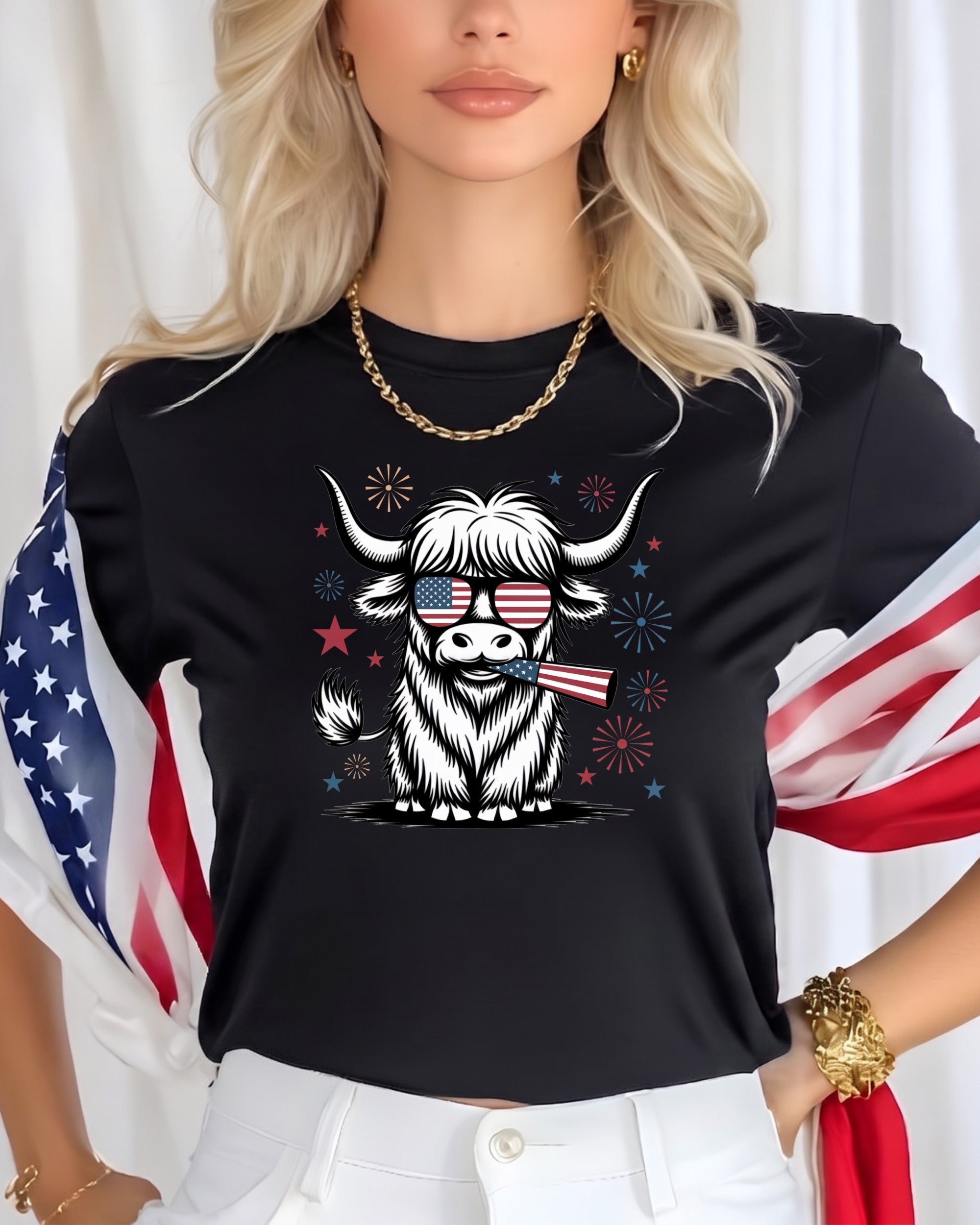 Highland cow with American flag sunglasses and fireworks graphic on black t-shirt.