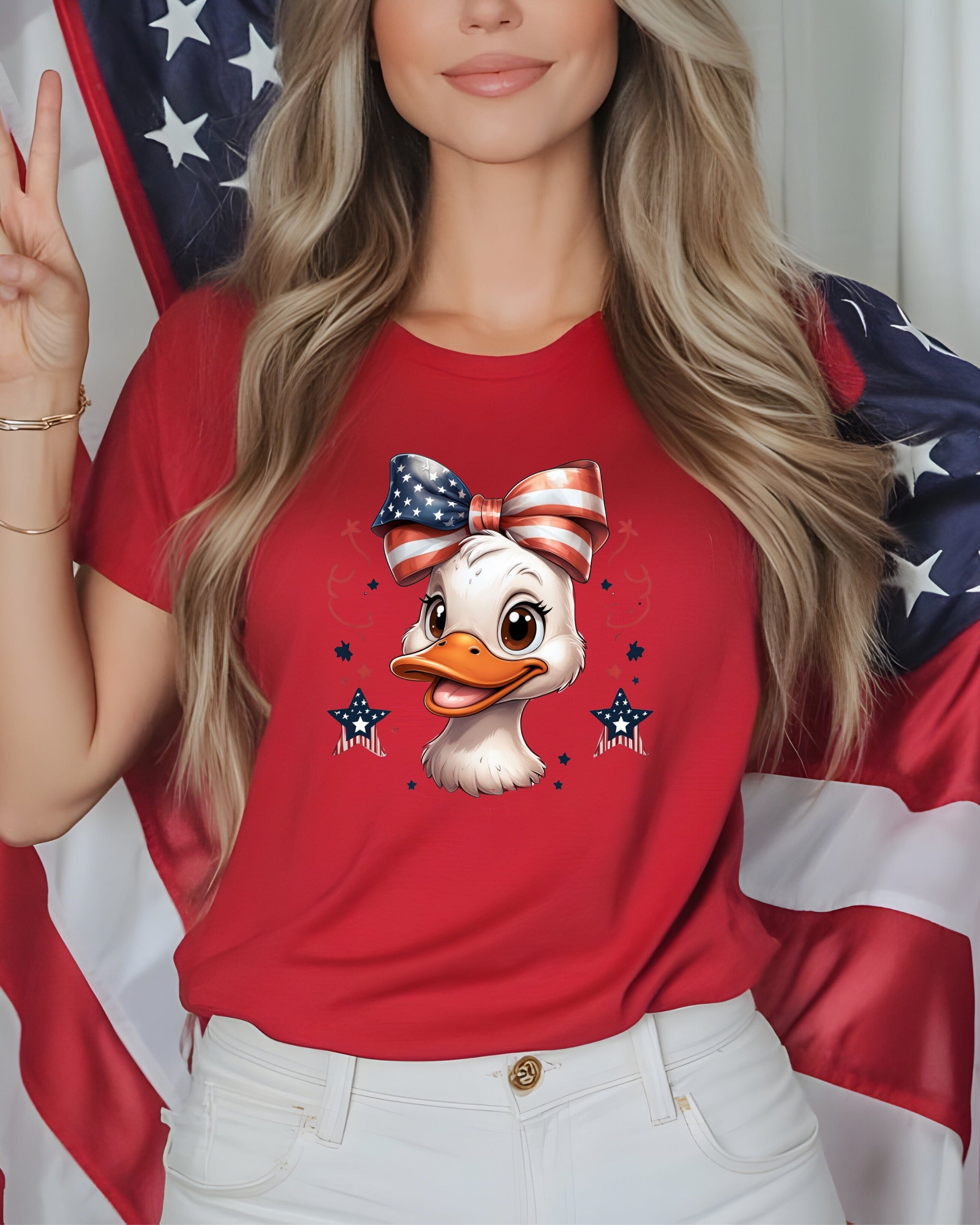 Woman wearing a red t-shirt with a cartoon duck wearing a patriotic bow.