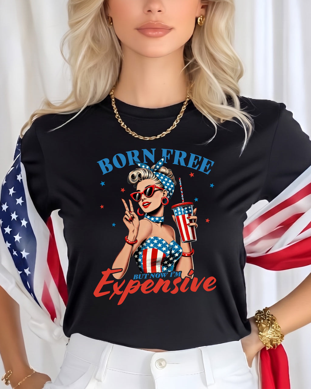 Black t-shirt with American flag graphic and "Born Free But Now I'm Expensive" text.