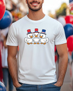 Three cartoon ducks wearing patriotic hats on a white t-shirt.